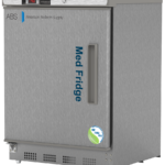 A stainless steel vaccine medical refrigerator by American BioTech Supply labeled Med Fridge. It has a digital temperature display on the top left, a vertical handle on the left hinged door, and NSF/ANSI 456 compliant certification stickers on the bottom right corner.