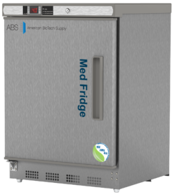 A stainless steel vaccine medical refrigerator by American BioTech Supply labeled Med Fridge. It has a digital temperature display on the top left, a vertical handle on the left hinged door, and NSF/ANSI 456 compliant certification stickers on the bottom right corner.