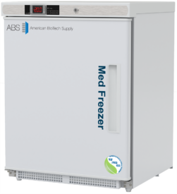 A white, upright medical vaccine freezer by American BioTech Supply features a digital temperature display, Med Freezer text on the door, a recessed handle that opens on the left side, and certification labels. The appliance is compact, with a plain, clinical design and is NSF/ANSI certified.