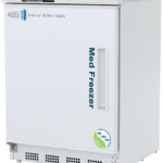 A white, compact medical vaccine freezer by American BioTech Supply with a digital temperature display showing -20.0°C. The door reads Med Freezer with an NSF/ANSI 456 certification logo. The handle is vertical on the left side, and ventilation grilles are at the bottom.