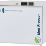 White premier freestanding countertop freezer with ABS American BioTech Supply logo, digital temperature display showing -20.0°C, and blue Med Freezer text on the side. NSF/ANSI 456 certification badge is visible on the bottom right corner.