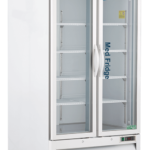 A 36 cu ft glass door pharmacy refrigerator white, upright cabinet, multiple internal shelves, and wheels. The label “MedFridge” is on the right door, and the control panel is at the bottom with vents. The brand “ABS” appears on the top left.