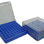 Two blue plastic racks with clear lids, each holding an 8x12 grid of circular slots for storing laboratory tubes. One rack’s lid is open and upright, the others lid is closed and labeled with letters and numbers for organization. Background is white.